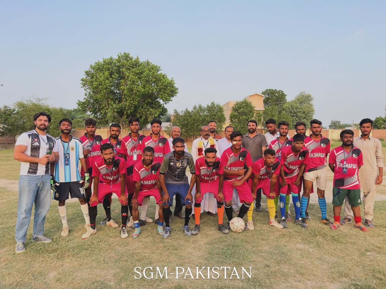 SGM youth sports soccer team posing together on an outdoor field during a community athletic event.